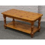 A stained pine two tier coffee table.