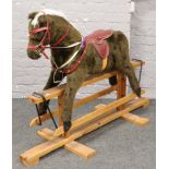 A rocking horse on pine base by Pegasus of Crewe, 98cm wide, 145cm long.