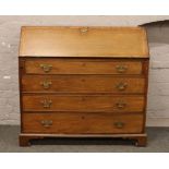 A Georgian mahogany bureau over four drawer chest with fitted interior raised on bracket feet, 125cm