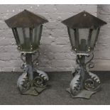 A large pair of metal and wrought iron gate post lanterns of hexagonal form and with acanthus
