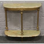 An onyx and gilt metal two tier demi lune side table.