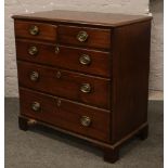 A Georgian mahogany two over three chest of oak lined drawers raised on bracket feet, 98cm W x