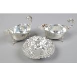 A pair of George V silver sauce boats assayed Birmingham 1932 and a pierced silver dish raised on