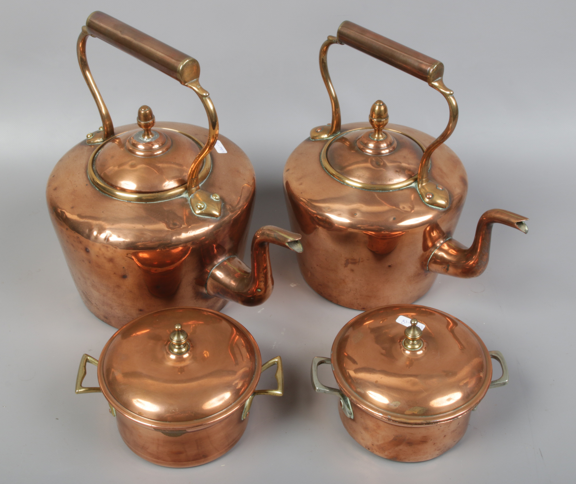 Two 19th century copper kettles and a pair of copper cooking pots with covers.