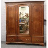 A George V plum pudding mahogany triple wardrobe with mirrored centre and fitted press to left