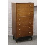 A mahogany G plan Wellington chest of 7 graduated drawers raised on painted base.