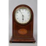 An early 20th century mahogany cased dome top mantle clock with boxwood strung inlay and white