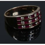 A 9ct gold ruby and diamond three row channel set ring. Size M.