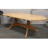 A twin pedestal pine dining table, 240cm x 99cm.
