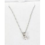 A 9ct white gold and solitaire diamond pendant on trace chain. Set with a brilliant cut diamond