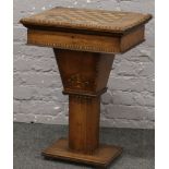 A Victorian walnut centre pedestal work table with fitted interior and parquetry inlaid gaming board