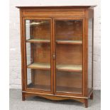 An Edwardian inlaid mahogany bookcase.