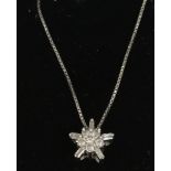 A 9ct white gold and diamond snowflake cluster pendant on box chain.
