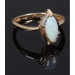 A 14ct gold marquise opal and diamond ring. Size O.