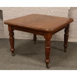 A Victorian wind out dining table raised on turned castered legs.