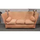 A pink upholstered Knole dropside sofa for re-upholstery.