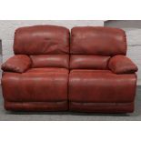 An oxblood brushed leather reclining two seater settee and armchair.