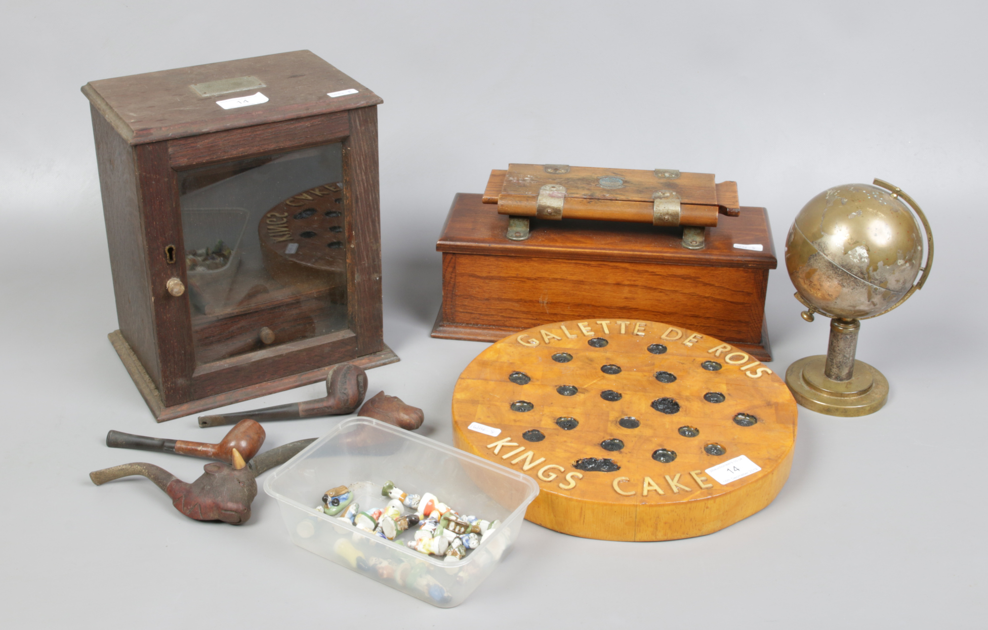 A John Watts ironing tie press, an oak pipe cabinet, globe cigarette dispenser, a Galette de Rois