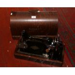 A Singer sewing machine in oak dome top case.