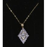 A 9ct gold tanzanite and diamond lozenge shaped pendant on chain.