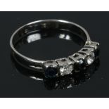 A platinum ring set with diamonds and sapphires, size M1/2.