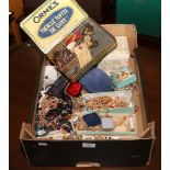 A large box of vintage costume jewellery mainly beads.