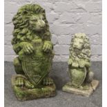 A cast concrete model of a Lion with welcome shield 60cm tall along with another.