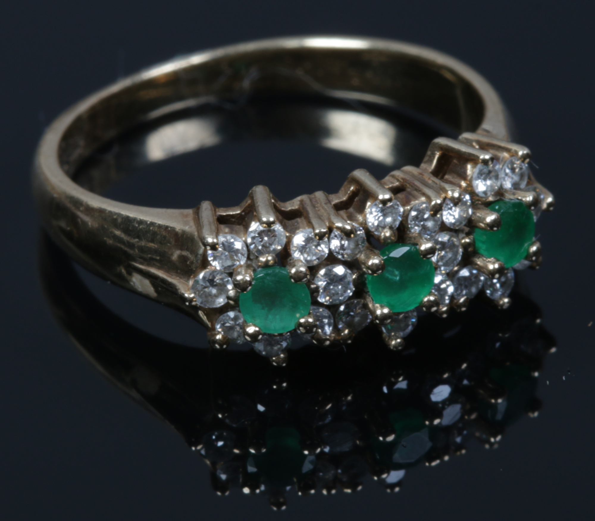 A 9ct gold emerald and diamond triple cluster ring. Size K.