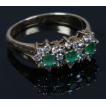 A 9ct gold emerald and diamond triple cluster ring. Size K.