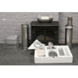 A cast iron Clarendon & Ashdon gas stove with stainless steel flu and installation manual.