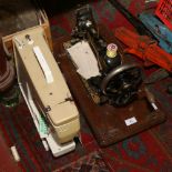 A hand cranked Jones sewing machine along with a Jones electric sewing machine.