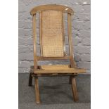 A 19th century folding campaign chair with canework seat and backrest.