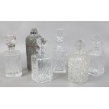 Five cut glass decanters along with a wire work soda syphon.