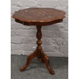 A mahogany inlaid occasional table raised on turned supports.