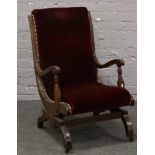 An Edwardian carved mahogany American rocking armchair.