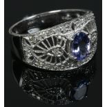 A 14ct white gold, tanzanite and diamond ring with a milgrain openwork setting. Size O.Condition