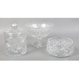 A cut lead crystal pedestal bowl, another bowl and a biscuit jar and cover.