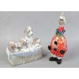 A Lladro model of four dogs on a crate and a Murano glass decanter formed as a clown.
