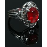An 18ct white gold padparadscha sapphire and diamond ring with certificate, size N. (5.81g).