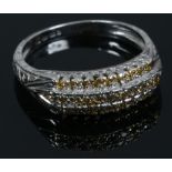 A 14ct white gold ring set with three rows of champagne diamonds, size O.