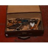 A vintage suitcase to include a collection of hand tools.