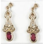 A pair of 9ct gold garnet and diamond pendant earrings.