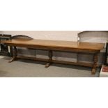 A very large 12 seat oak three pillar refectory table with four plank top and carved frieze, 357cm x
