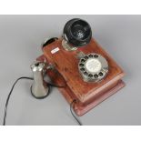 A vintage wall mounted telephone MKXVAP Tele MFG CO. London 1950