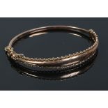 A 9ct gold bangle with beaded edge, 6.1 grams.