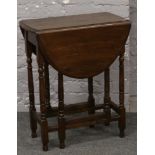 An oak gate leg table of small proportions.