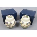 Two boxed Moorcroft lidded jars both in the Hepatica design.