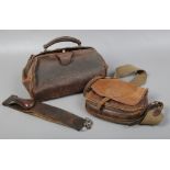 A leather barbers strop, gladstone bag and a satchel marked H.M.B.