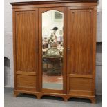 An Edwardian mahogany triple wardrobe / linen press.