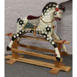 A carved rocking horse with dappled grey painting and having sable mane and tail, 115cm high,